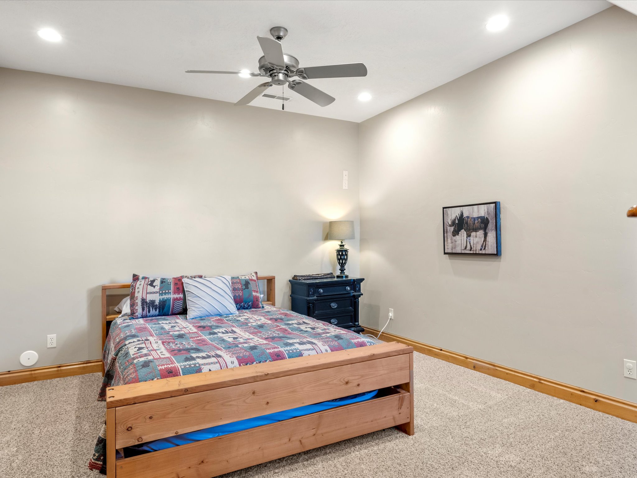 Carpeted room featuring a ceiling fan with integrated lighting, recessed ceiling lights, and wood baseboard trim