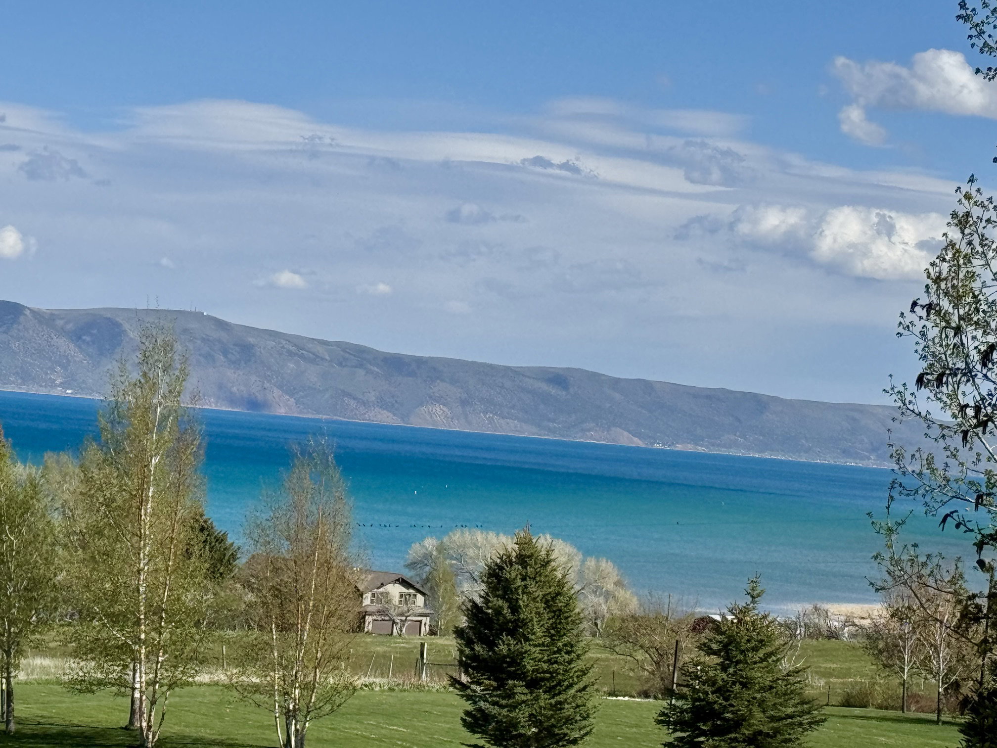 Expansive water body with surrounding mountains