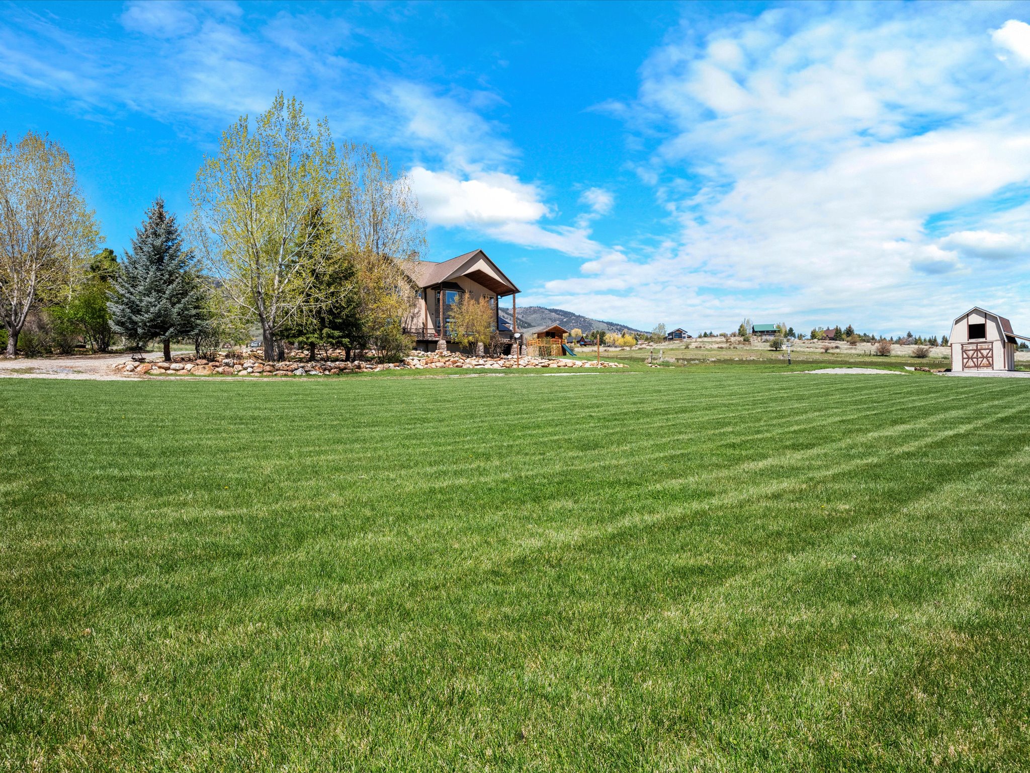 Expansive green lawn with visible mow lines