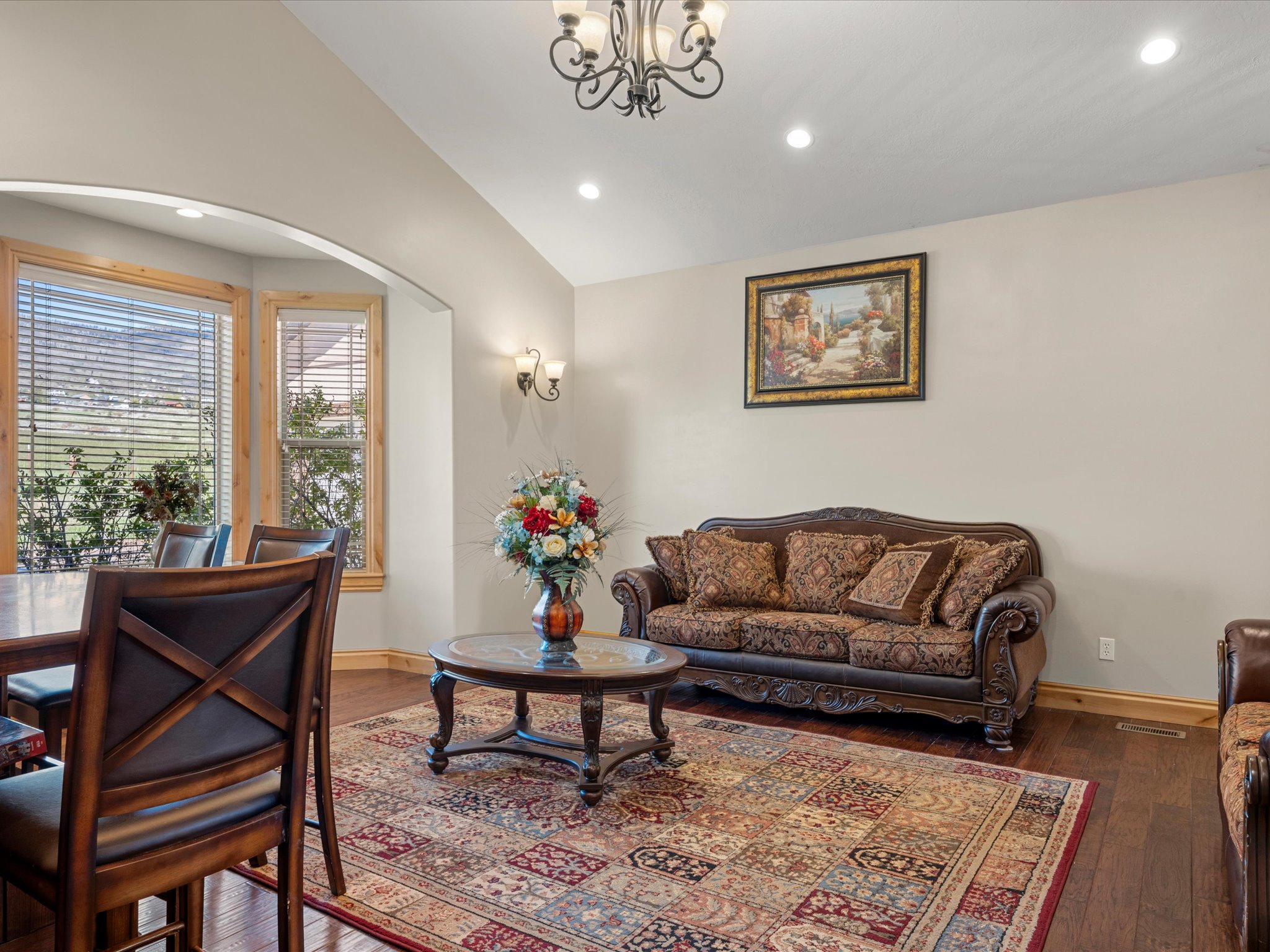 Formal living room a with bay windows and a cased opening