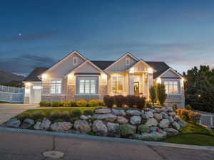 Craftsman-style home featuring a stone and siding exterior, multi-pane windows