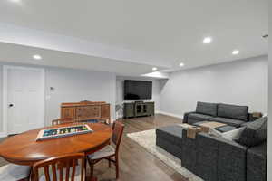 Enjoy the game table area with recessed lighting illuminating wood-finish flooring