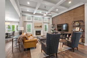 Living area featuring coffered ceilings, recessed lighting, and wood-finish flooring