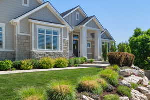 Contemporary exterior featuring stone accents, shake siding, and board-and-batten elements