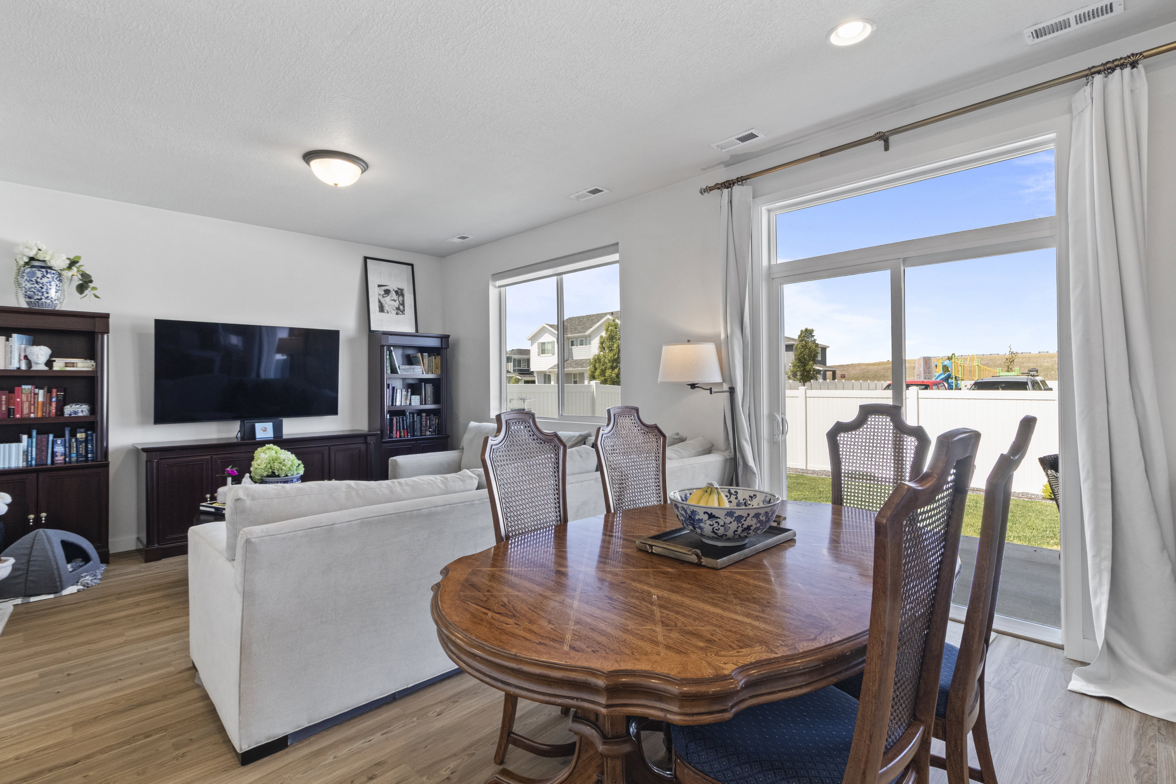 Open-concept living space featuring LVP flooring, recessed lighting, and a sliding glass door providing access to the exterior