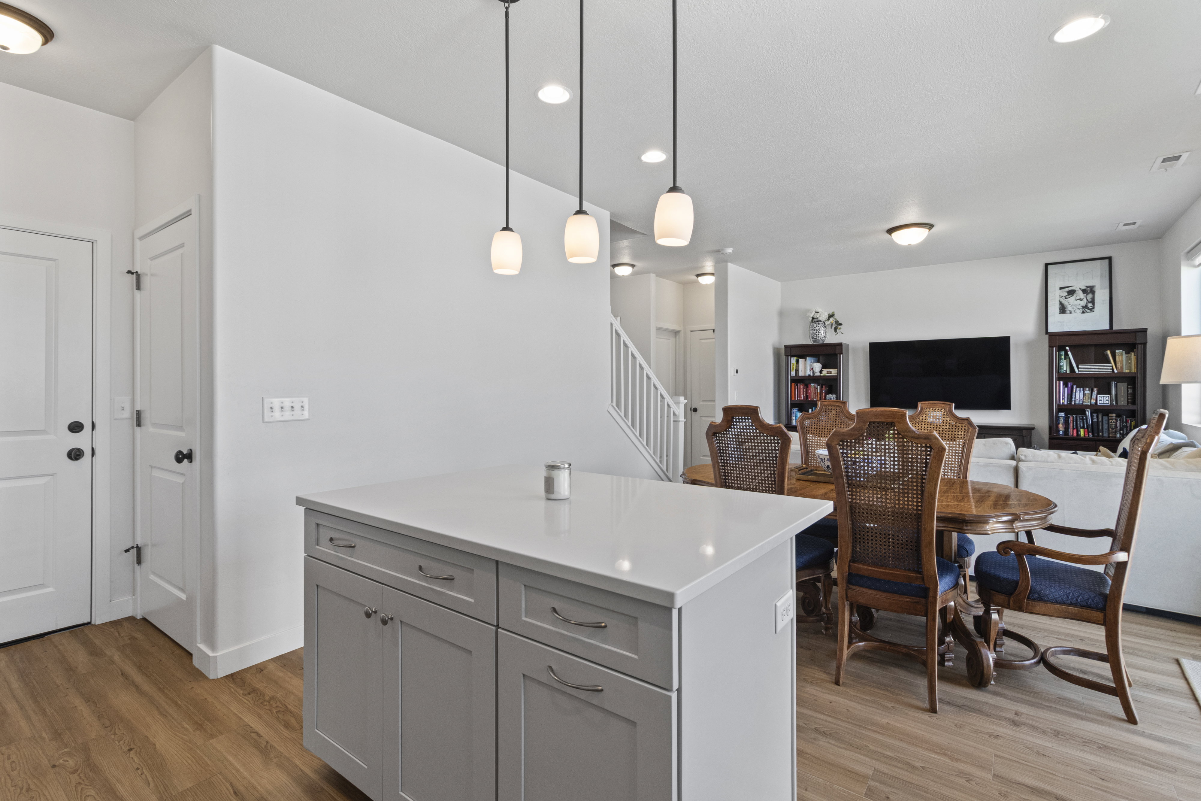 Kitchen island featuring a light-toned countertop and cabinetry