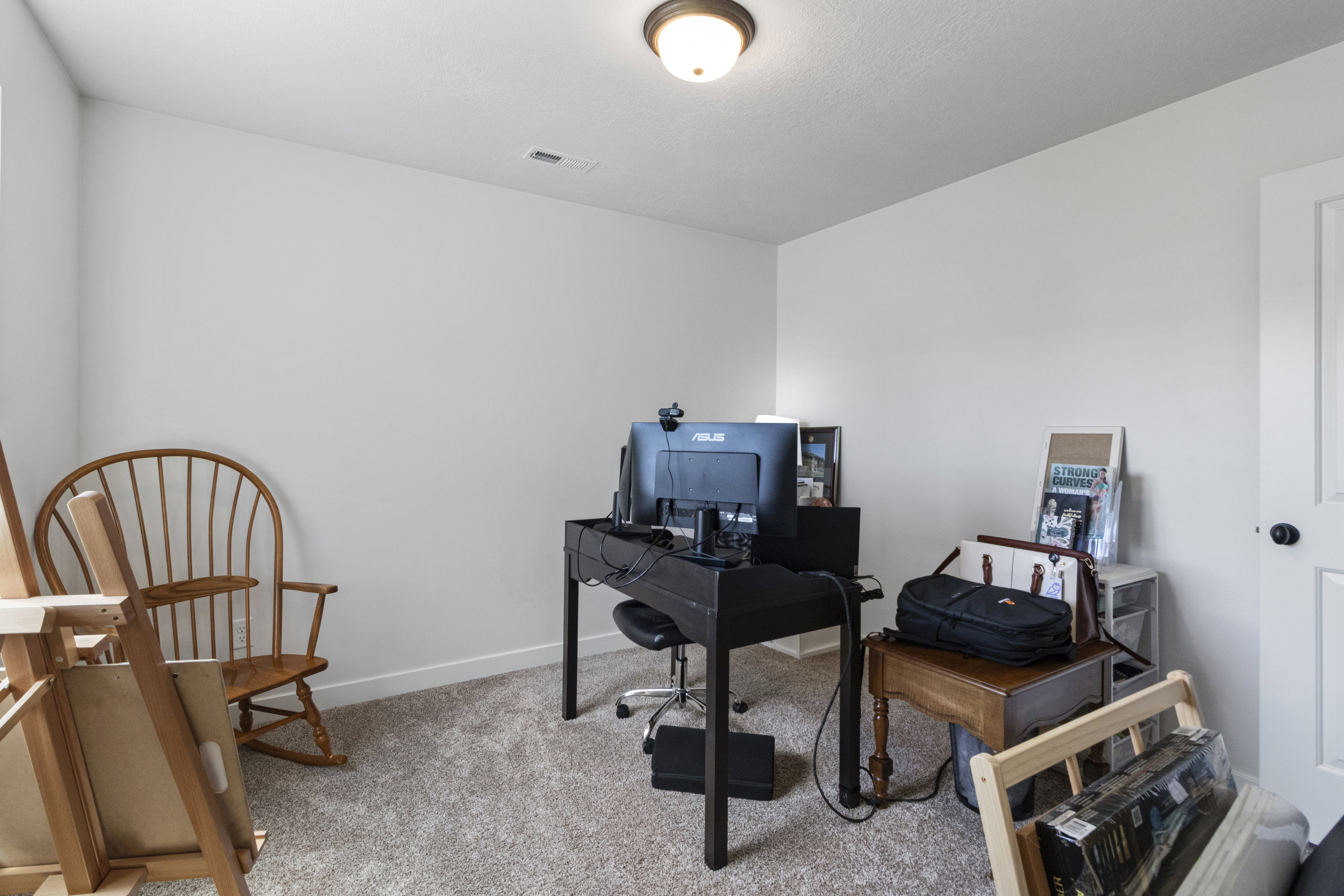 Interior room with neutral wall color and textured carpeting