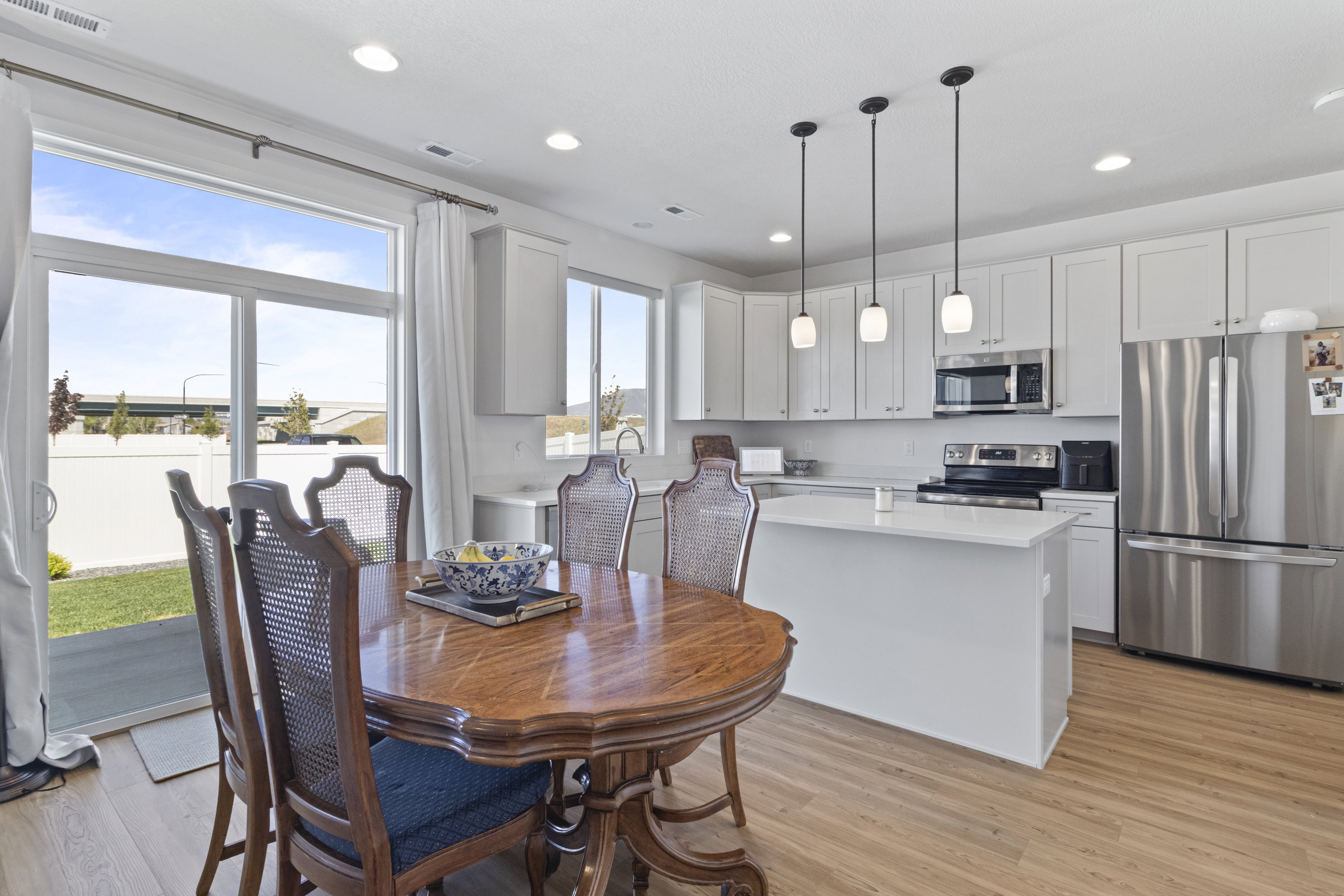 Modern kitchen featuring white cabinetry, stainless steel appliances, a center island with a white countertop, and recessed lighting
