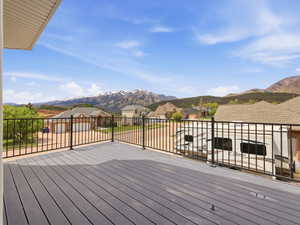 Spacious outdoor deck with composite decking and black metal railings, offering expansive mountain scenery