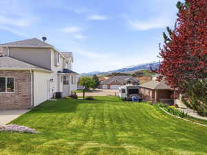Expansive green lawn with mountain backdrop