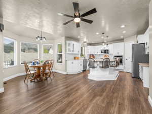 Open-concept living space featuring wood-finish flooring and a contemporary ceiling fan