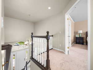 Split-level entryway featuring a white paneled door with sidelights and an arched transom window