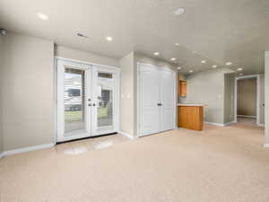 Spacious room featuring neutral carpeting and recessed lighting
