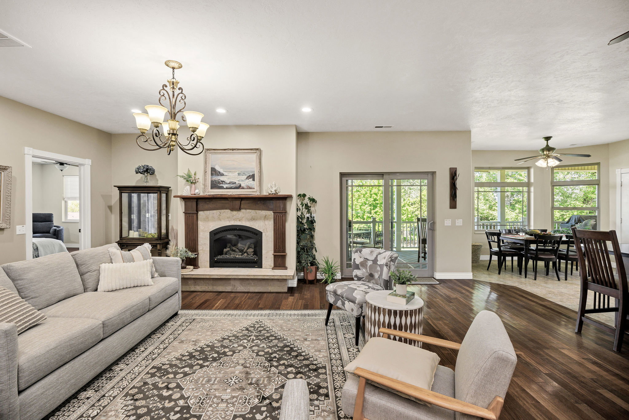 Living area featuring a stone fireplace with a wood mantle, wood-finish flooring, and recessed lighting