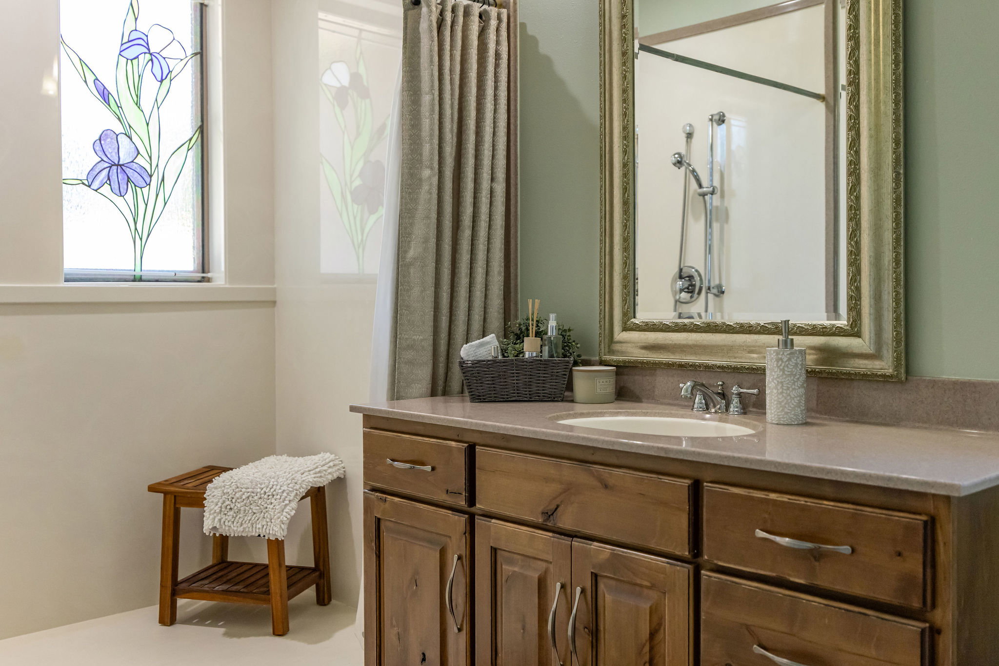 Bathroom vanity featuring an integrated sink, polished chrome faucet, and ample storage cabinetry