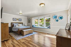 Spacious room featuring wood-finish flooring and a large bay window