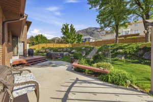 Expansive patio featuring a concrete surface and a tiered landscape
