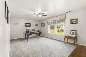 Spacious room with light gray wall paint and textured carpeting