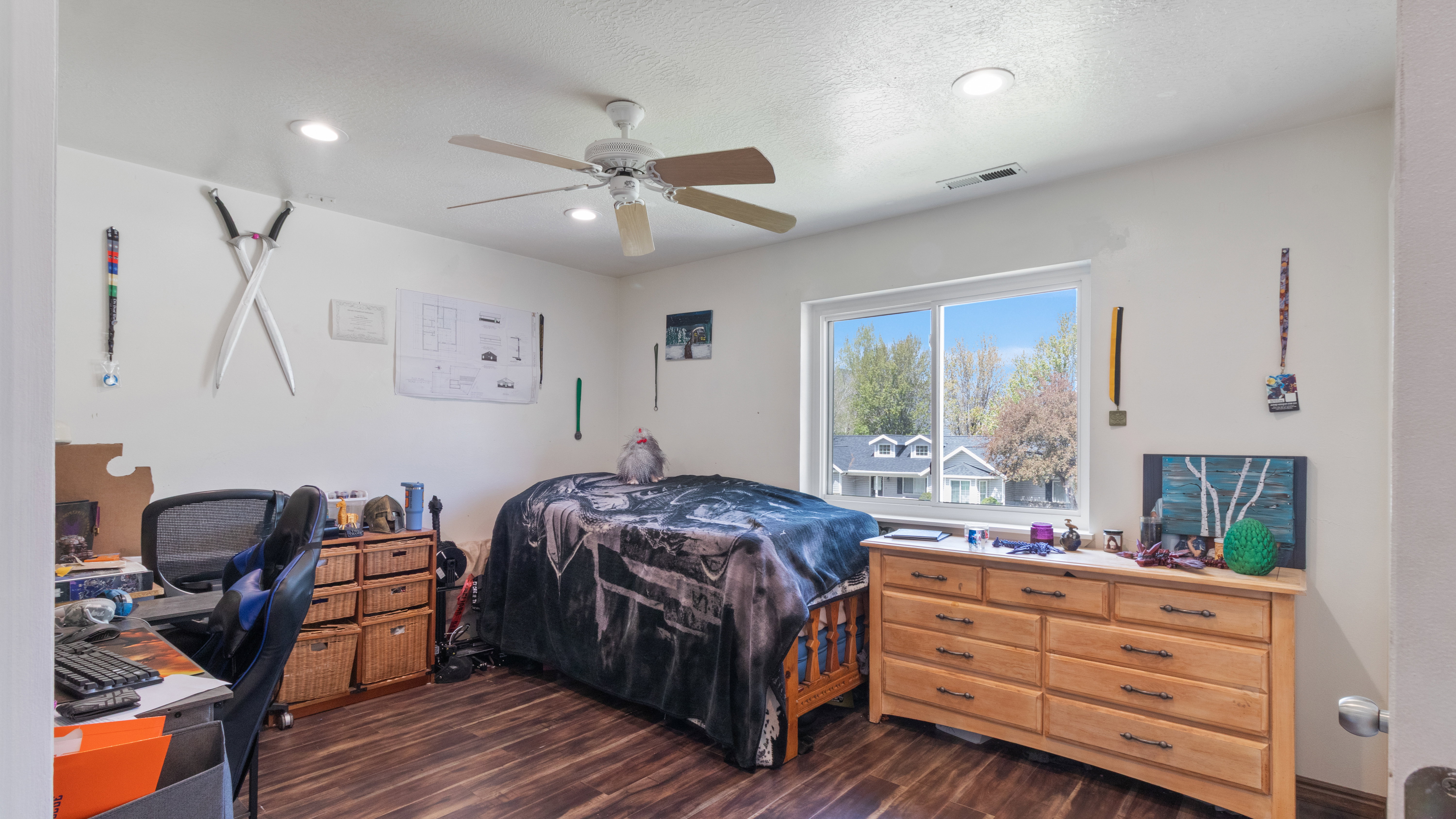 Bright room featuring wood-finish flooring, recessed lighting, and a ceiling fan
