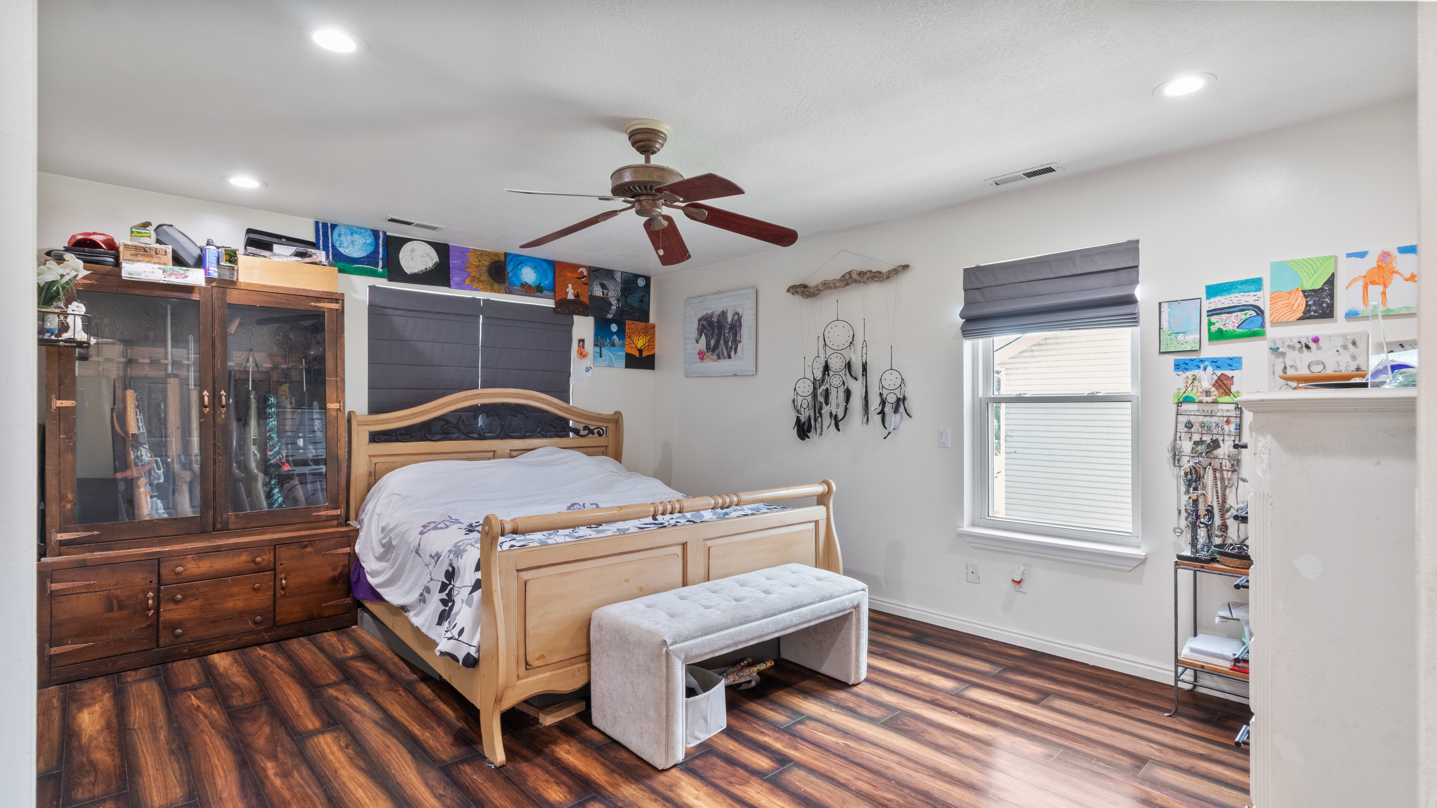 Spacious bedroom featuring wood-finish flooring, recessed lighting, and a ceiling fan