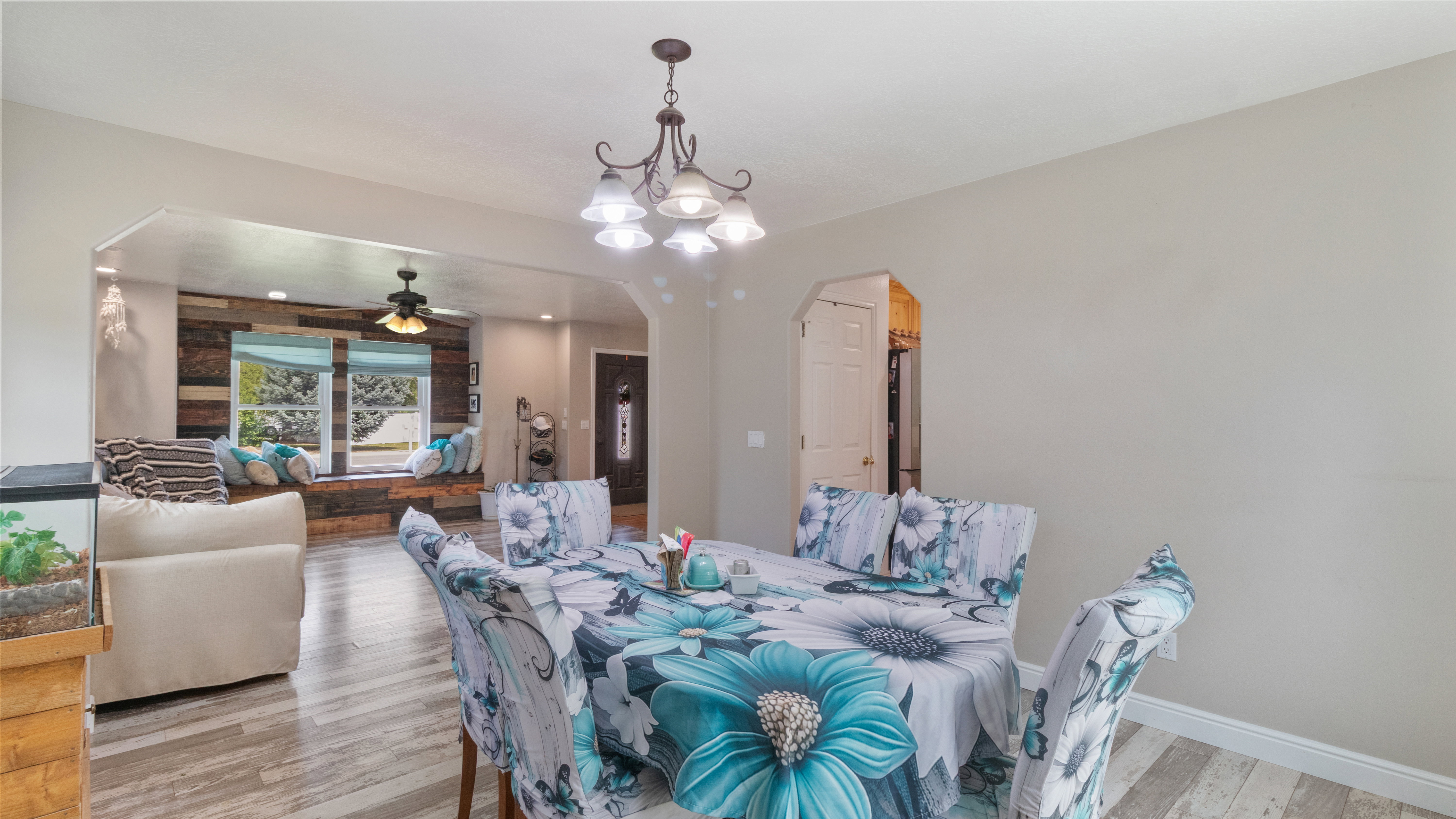 Dining area with wood-finish flooring and a decorative chandelier