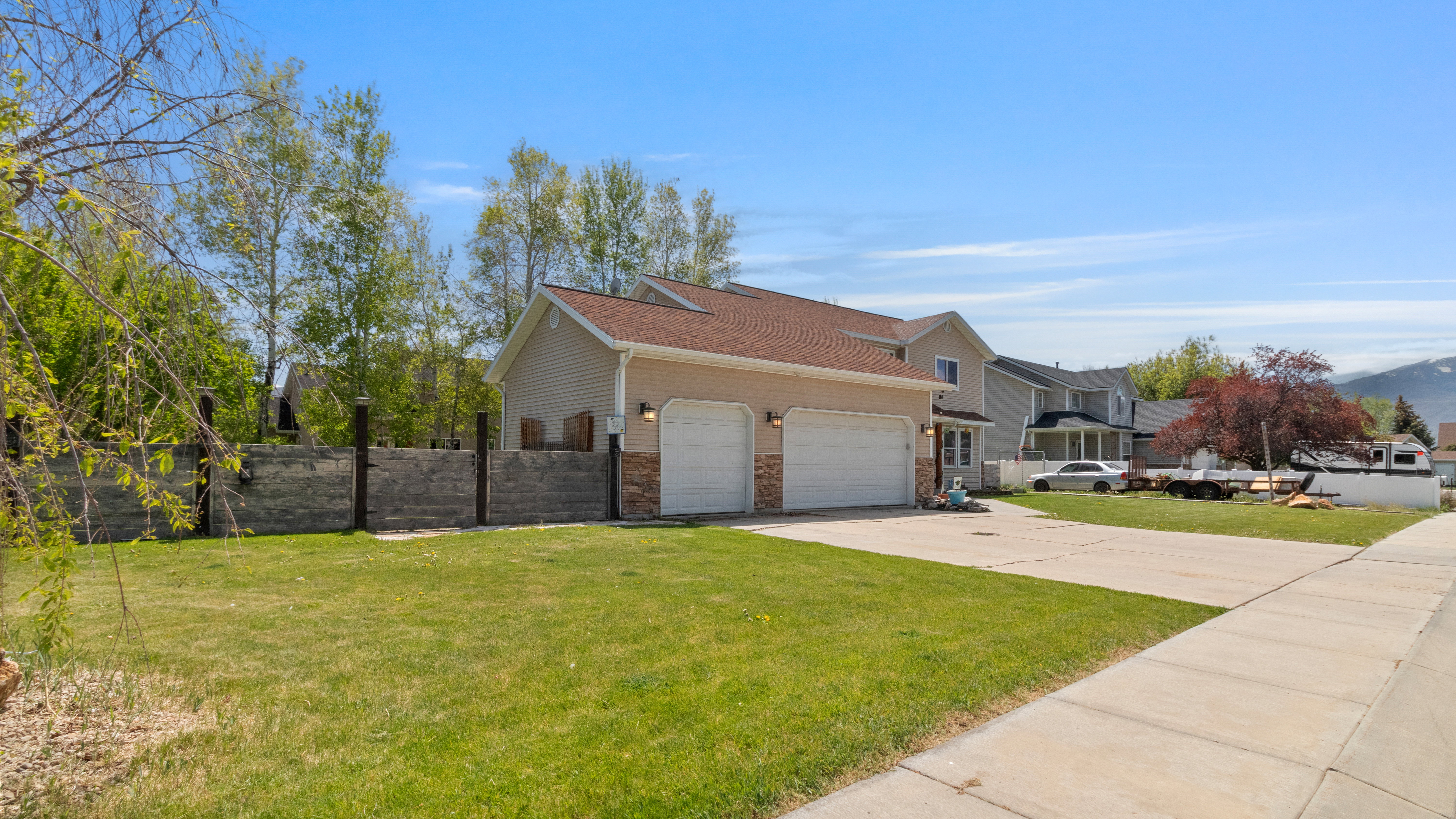 Two-story residence featuring a two-car garage with white paneled doors