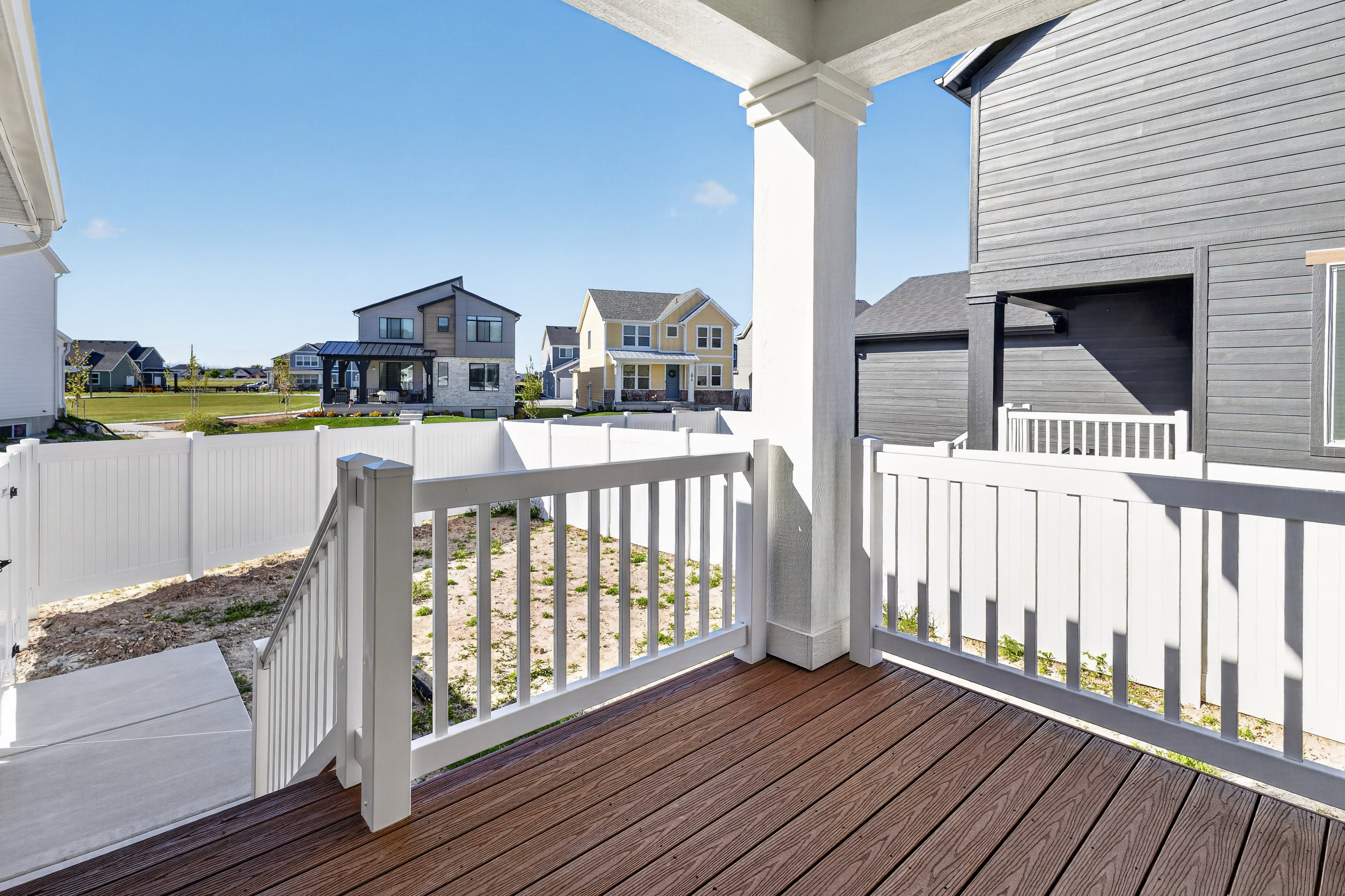 Spacious deck with composite wood-finish flooring and white railing