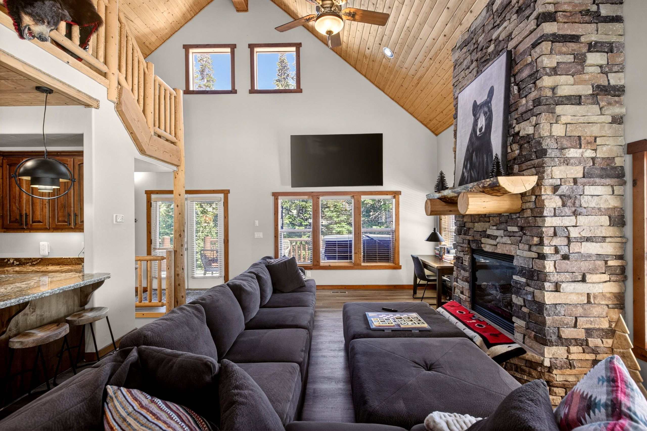 Vaulted wood-paneled ceilings with ceiling fan and recessed lighting