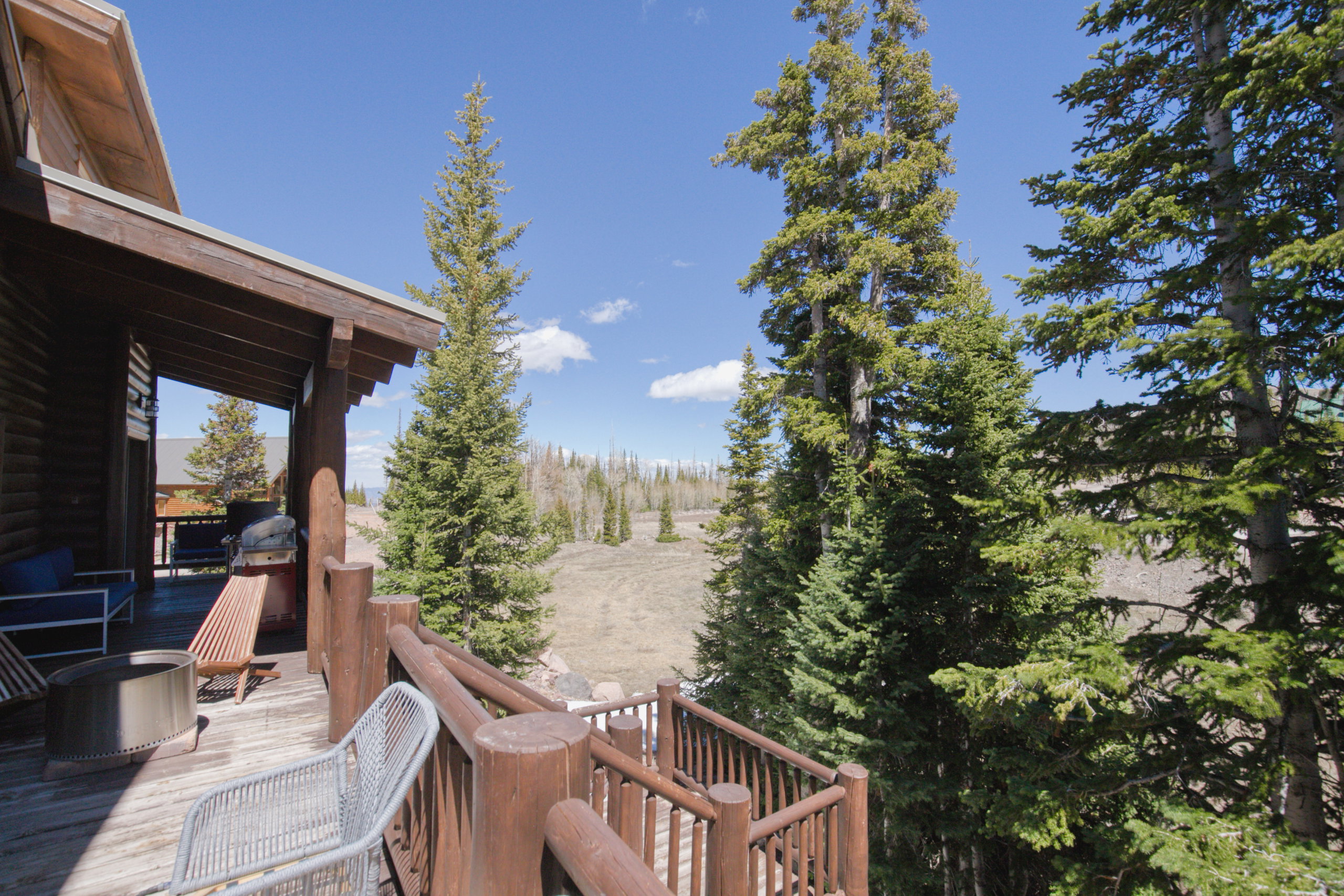 Expansive exterior deck featuring a natural wood finish and robust railing system