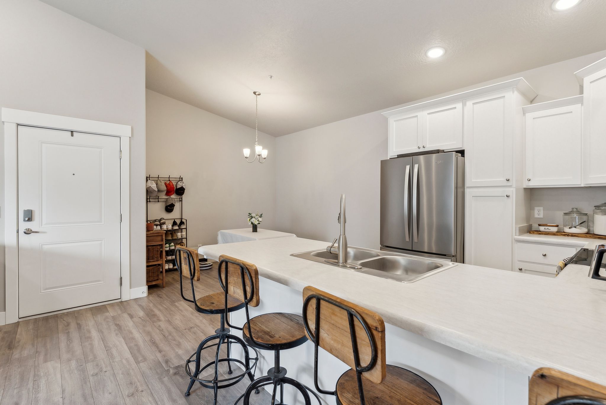 Kitchen island featuring a double basin sink and light-colored countertop
