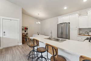 Kitchen island featuring a double basin sink and light-colored countertop