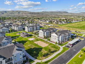 Aerial perspective showcasing a multi-building residential complex with mountain backdrop