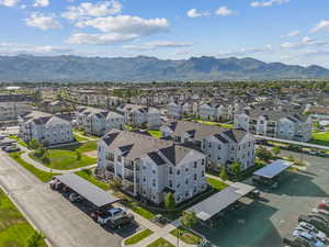 Residential community featuring multi-story buildings with light blue siding and dark roofs