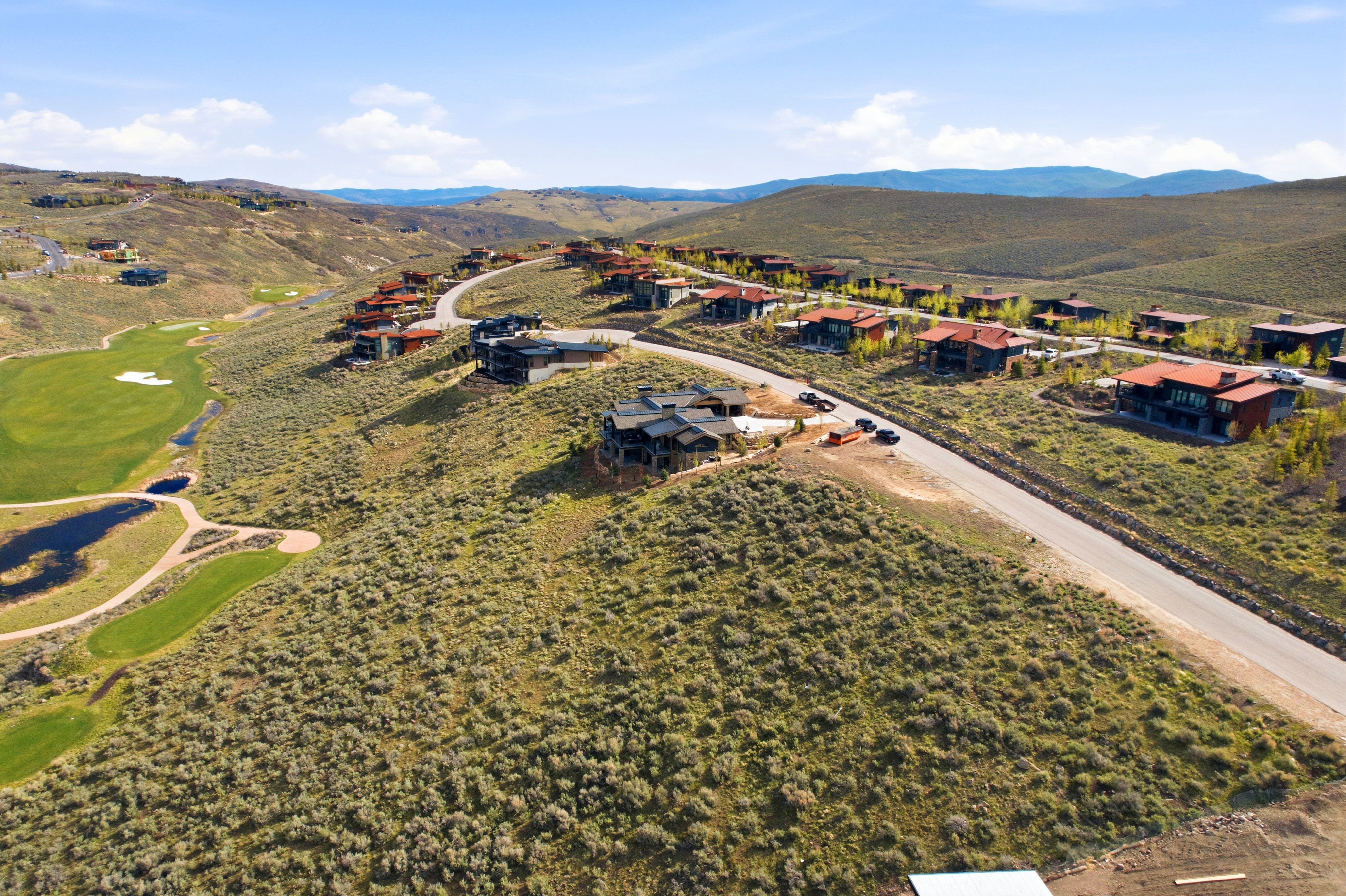 Golf course community featuring hillside residences and paved roadways