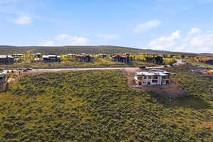 Developing hillside residential area featuring a partially constructed contemporary residence