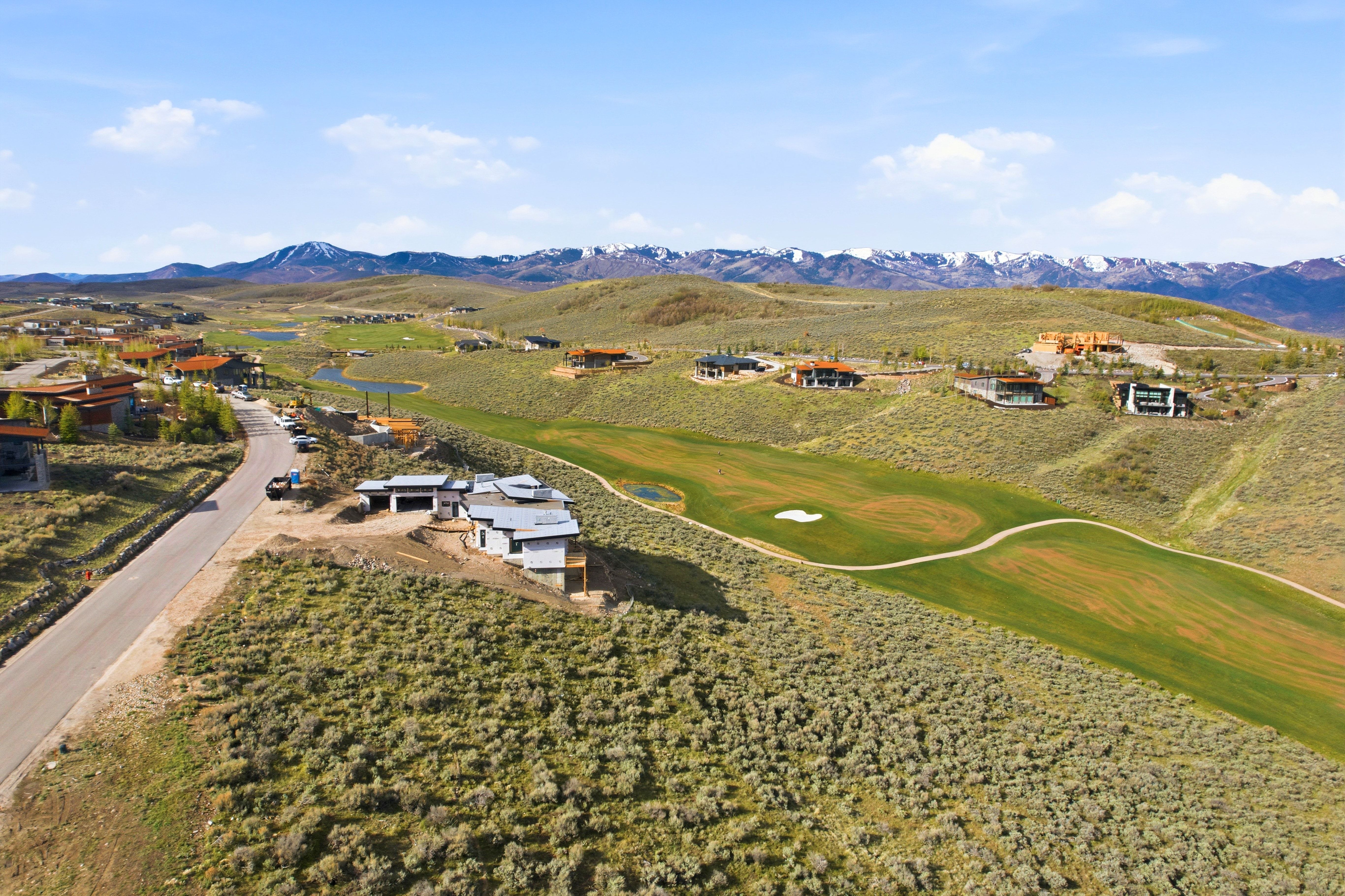Expansive residential community with golf course frontage and distant mountain peaks