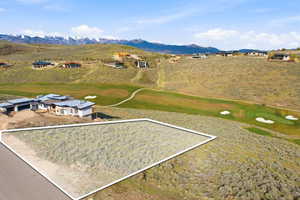 Expansive land parcel featuring natural shrubbery and a clear, level building area