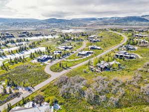 Aerial rendering of a residential area featuring multiple properties amidst natural landscaping and paved roadways