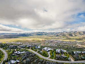 Expansive mountain landscape featuring distant snow-capped peaks