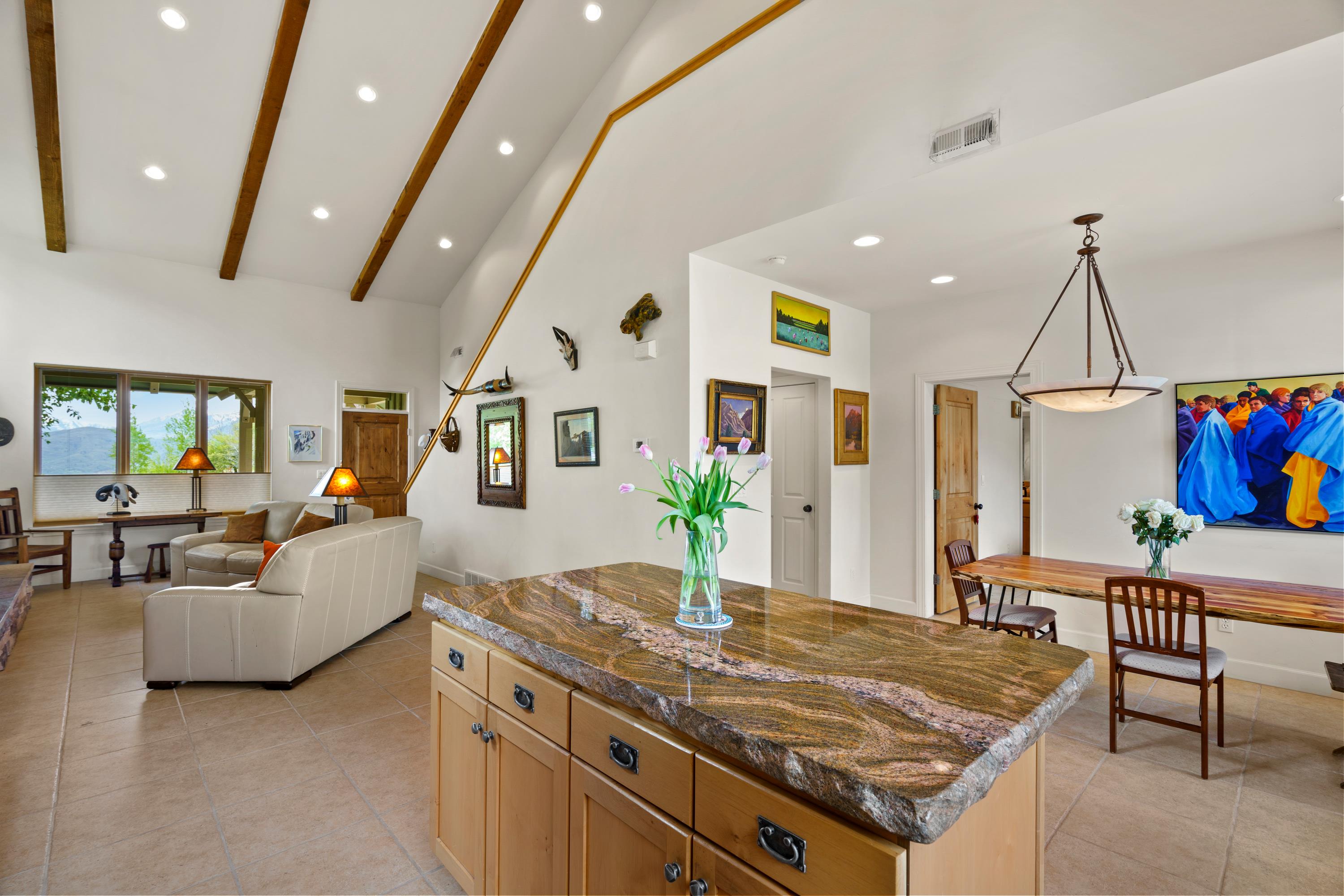 Vaulted ceiling featuring exposed wood beams and recessed lighting
