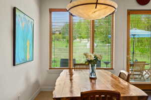 Hardwood dining table with natural edge, accompanied by wooden chairs