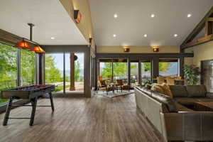 Open-concept interior featuring wood-finish flooring, recessed lighting, and expansive windows