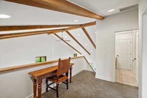 Loft area featuring exposed wood ceiling beams, recessed lighting, and a ceiling fan