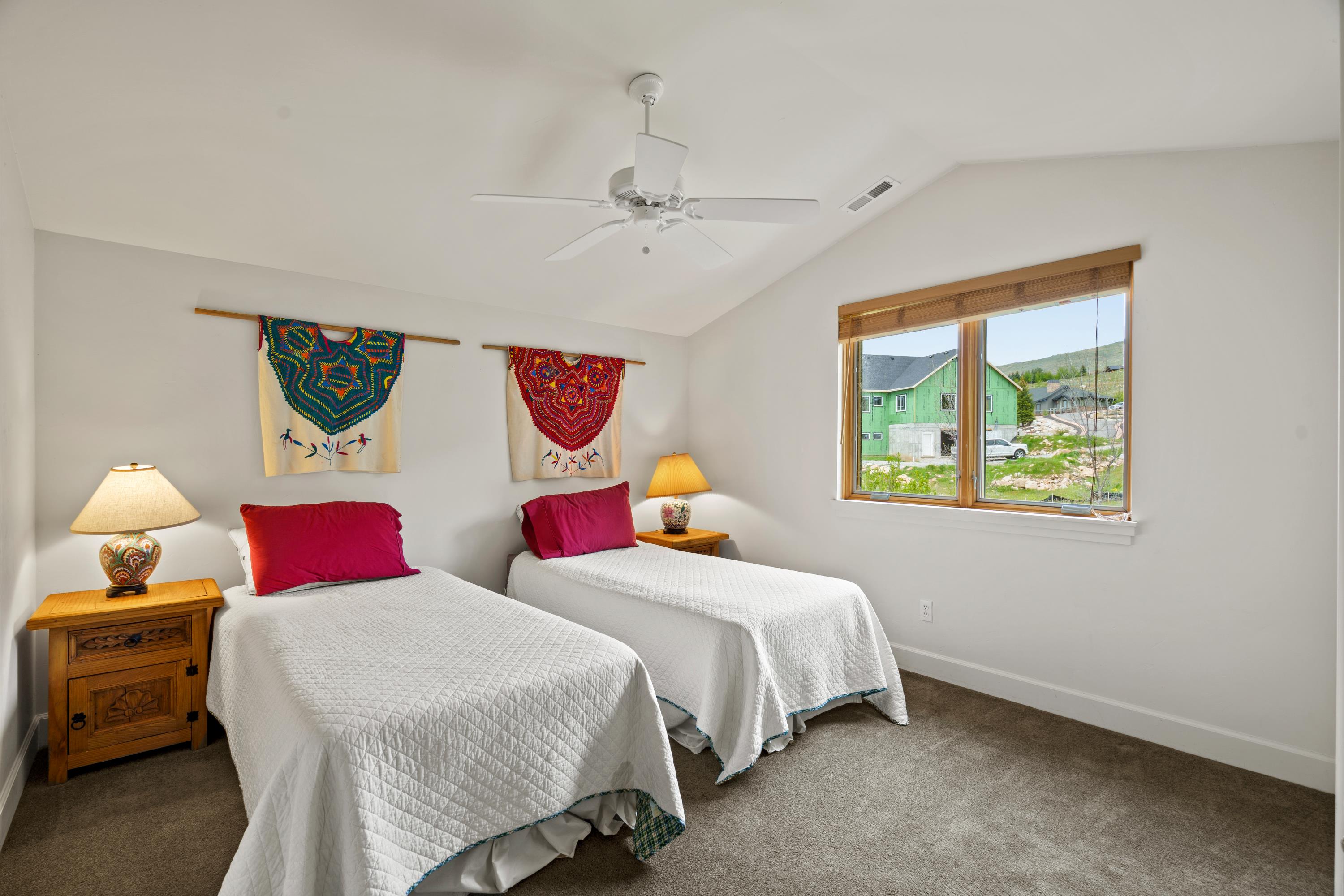 Room featuring a vaulted ceiling, white walls, and gray carpet