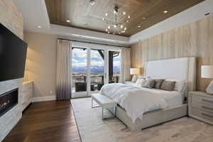 Expansive bedroom with a wood-finish accent wall and rich wood-finish flooring