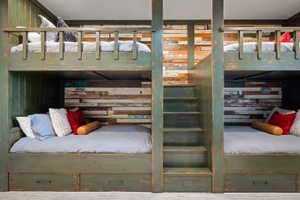 Custom-built bunk beds featuring a distressed green finish and integrated staircase