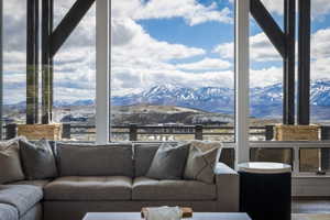 Floor-to-ceiling windows frame expansive mountain scenery