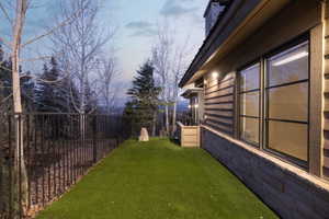 Exterior stone and wood-look siding with multiple windows