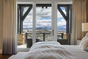 Sliding glass doors opening to a private balcony with mountain scenery