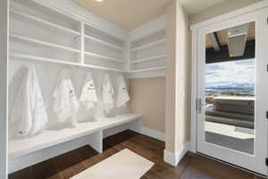 Built-in white shelving and bench seating with dark wood-finish flooring